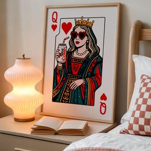 May include: A framed wall art print depicting a Queen of Hearts playing card. The queen wears a gold crown, heart-shaped sunglasses, and a pearl necklace, while holding a silver can labeled Diet Coke with a red and white striped straw.