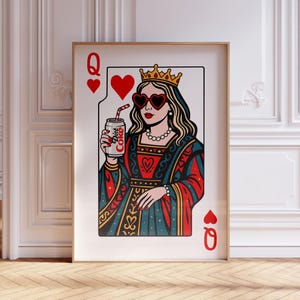 May include: A framed wall art print featuring a stylized Queen of Hearts playing card illustration. The queen wears a gold crown, heart-shaped sunglasses, and a pearl necklace, while holding a silver can labeled Diet Coke with a red striped straw.