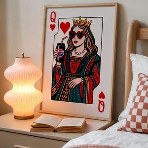 May include: A framed art print of a playing card, the Queen of Hearts, holding a Pepsi can. The queen wears heart-shaped sunglasses and a crown. The artwork is in a retro style with red, blue, and gold colors.