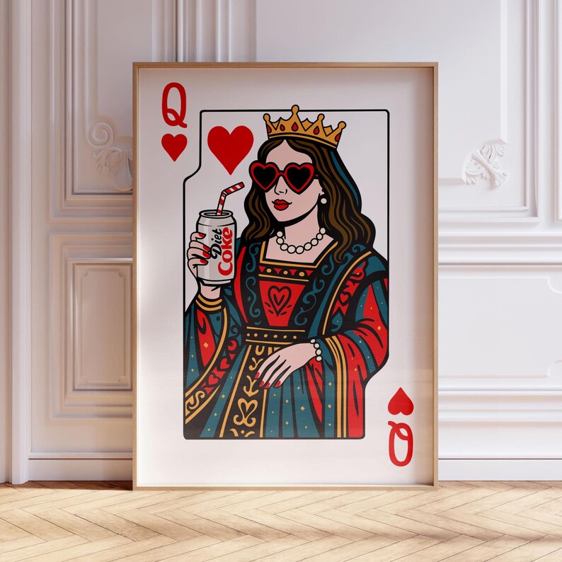 May include: A framed wall art print featuring a playing card design of a queen wearing a gold crown and heart-shaped sunglasses. The figure holds a silver can labeled Diet Coke with a red and white striped straw, set against a white background.