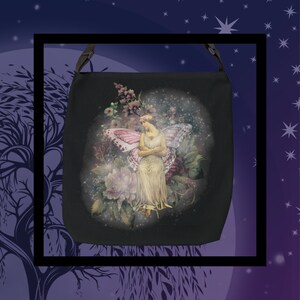 May include: A black canvas tote bag with a print of a fairy with pink wings sitting on a flower. The fairy is surrounded by flowers and sparkles.