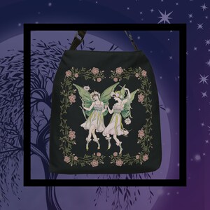 May include: Black tote bag with a floral design featuring two fairies with green wings and pink dresses. The fairies are holding hands and dancing in a circle of flowers.