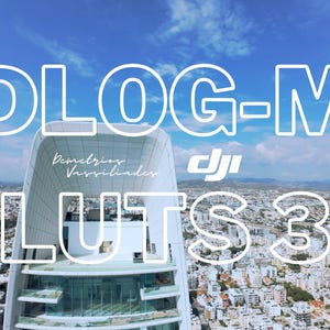 以下が含まれることがあります： 青い空の背景に白い文字で「DLOG-M LUTS 3」と表示され、その下にさらに小さな白い文字で「Demetrios Vassilindes」と表示されています。テキストは、湾曲した屋根を持つ白い建物の上に重ねられています。