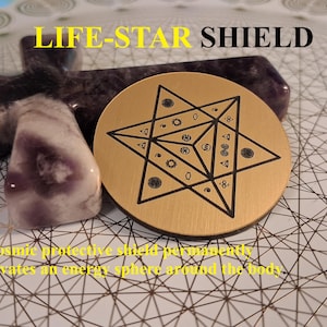 May include: A gold-colored circular shield with a black star design, next to a purple crystal and a cross-shaped stone. The text "LIFE-STAR SHIELD" is at the top, with additional text below.