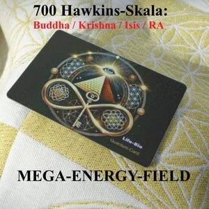 May include: A black card with gold and bronze geometric designs, an eye, and a pyramid. The card has the text "700 Hawkins-Skala: Buddha / Krishna / Isis / RA" and "MEGA-ENERGY-FIELD". The card also says "Life-Bio Quantum-Card".