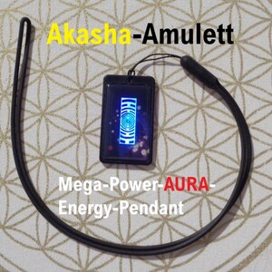 May include: Black rectangular pendant with a blue and white design, attached to a black cord. The pendant has the text "Akasha-Amulett" in yellow and "Mega-Power-AURA-Energy-Pendant" in white and red.