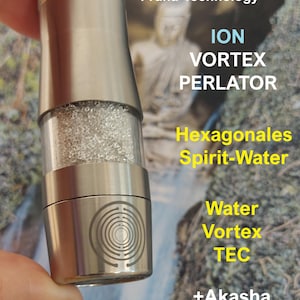 May include: A cylindrical metal water aerator featuring a clear central section filled with small light-colored beads. The device is engraved with a circular labyrinth pattern and includes the text 100 Light Balls Prana-Technology, ION VORTEX PERLATOR, Hexagonales Spirit-Water, Water Vortex TEC, +Akasha TEC, and +MWO-TEC.