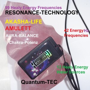 May include: A black pendant with a holographic design, hanging on a black cord, is displayed against a pink stone. Text on the image includes "99 Healy Energy Frequencies", "RESONANCE-TECHNOLOGY", and "AKASHA-LIFE". Additional text mentions "42 Energy Hz Frequencies" and "Quantum-TEC".
