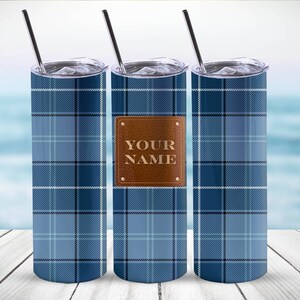 May include: Three stainless steel tumblers with a blue plaid pattern. The center tumbler has a brown leather patch with the text "YOUR NAME" on it.