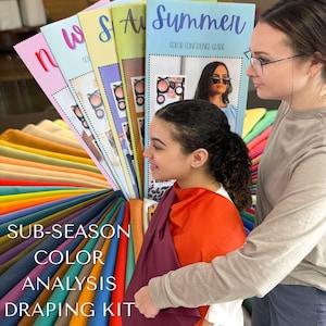 May include: A colour analysis draping kit with a variety of fabric swatches fanned out. The kit includes guides labelled "Summer", "Autumn", and "Winter". The text "Sub-Season Colour Analysis Draping Kit" is visible.