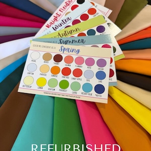 May include: A color palette guide with fabric swatches fanned out. The guide features color names and seasonal color analysis labels. The word "REFURBISHED" is printed in white at the bottom. The fabrics are in various colors, including pink, blue, and green.