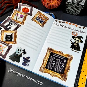 May include: A Halloween-themed journal spread with stickers and text. Stickers include a pumpkin, candy, a black cat, and a ghost. The text reads "Trick or Treat" and "Trick or Treat yourself to more stickers". The journal is open on a black surface.