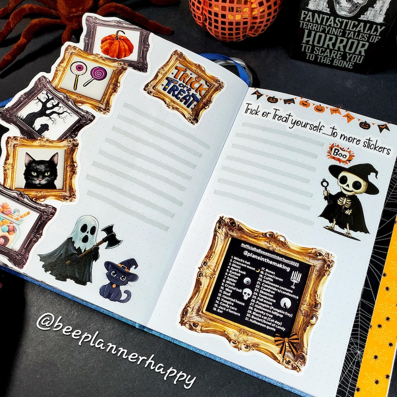 May include: A Halloween-themed journal spread with stickers and text. Stickers include a pumpkin, candy, a black cat, and a ghost. The text reads "Trick or Treat" and "Trick or Treat yourself to more stickers". The journal is open on a black surface.