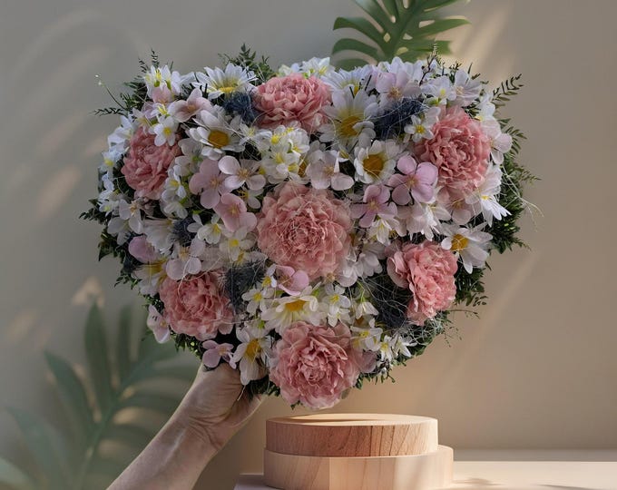 Pink Heart-Shaped Flower Wreath: An elegant outdoor memorial for All Saints' Day. Custom colors available for a lasting tribute