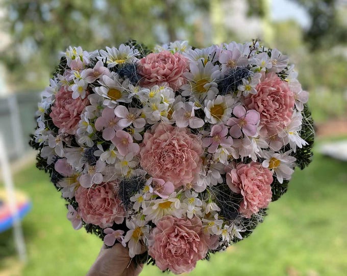 Pink Heart-Shaped Flower Wreath: An elegant outdoor memorial for All Saints' Day. Custom colors available for a lasting tribute