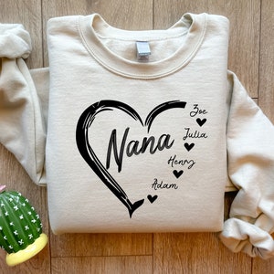 May include: A cream-colored sweatshirt with a black heart design that says "Nana" inside the heart.  The names Zoe, Julia, Henry, and Adam are written around the heart with small black hearts next to each name.