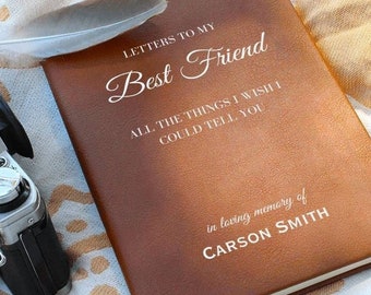 May include: A brown leather journal with the text "Letters to My Best Friend" and "All the things I wish I could tell you" in white lettering. The journal also has the text "in loving memory of CARSON SMITH" in white lettering.