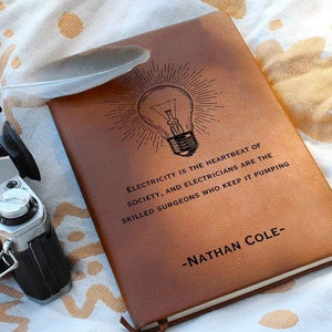 May include: A brown leather-bound journal with a light bulb graphic and the quote "Electricity is the heartbeat of society, and electricians are the skilled surgeons who keep it pumping." -Nathan Cole-