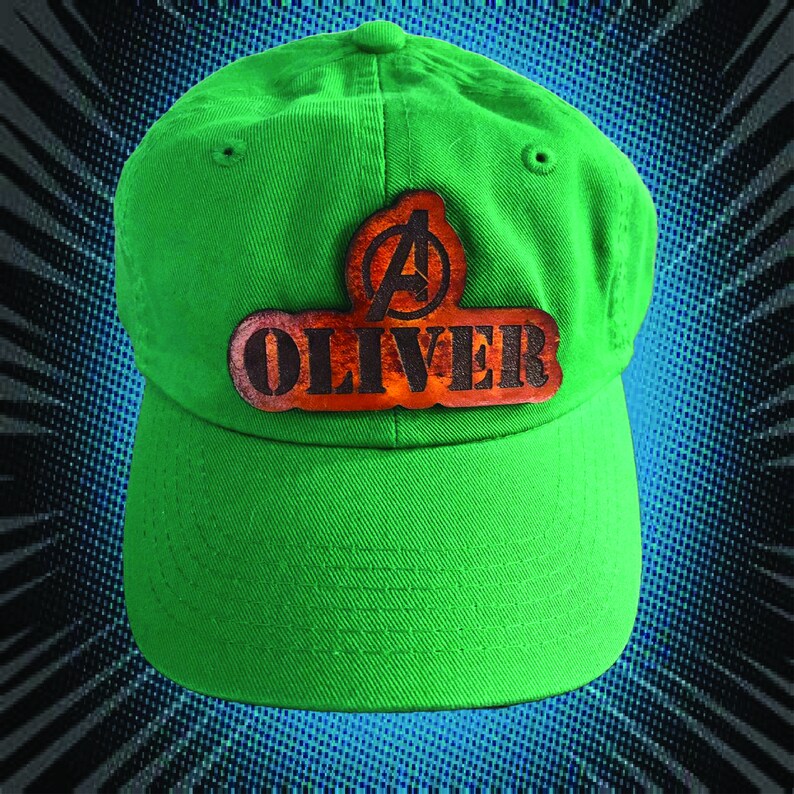 May include: Green baseball cap with a brown leather patch that says "OLIVER" with an Avengers logo above the name.