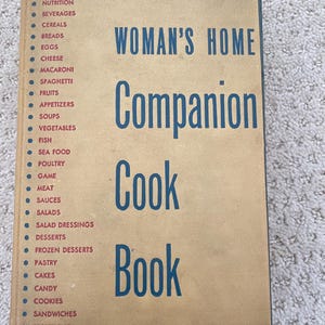 May include: A white ceramic mug with a black handle and the text "But First, Coffee" in a black, bold font. The mug is sitting on a white surface.