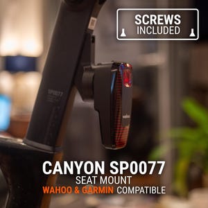May include: Black seat mount for Canyon SP0077, compatible with Wahoo and Garmin devices. The image shows a black seat mount with a red light and the text "SCREWS INCLUDED".