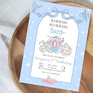 May include: A light blue birthday invitation with a fairytale theme. The invitation features a carriage, birds, and the words "Bibbidi Bobbidi Two." The invitation includes the date, time, and location of the party.