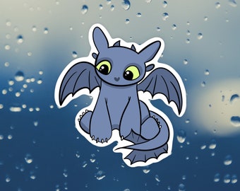 May include: A cartoon illustration of a cute, blue, dragon with green eyes and a small, curled tail. The dragon is sitting on a blue background with white raindrops.