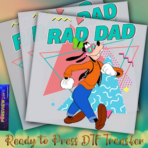 May include: A white iron-on transfer with a cartoon dog wearing sunglasses and a bright orange shirt. The dog is standing on a geometric pattern with the text "Rad Dad" in teal and white.
