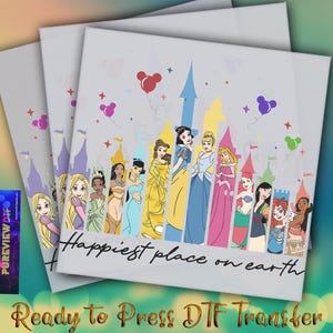 May include: A white iron-on transfer design featuring a line of Disney princesses standing in front of a castle with the text "Happiest place on earth".