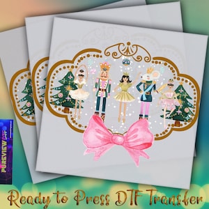 May include: Three white rectangular DTF transfer sheets featuring a watercolor design of characters from The Nutcracker ballet. The design includes a pink bow, Christmas trees, and the text "Ready to Press DTF Transfer".