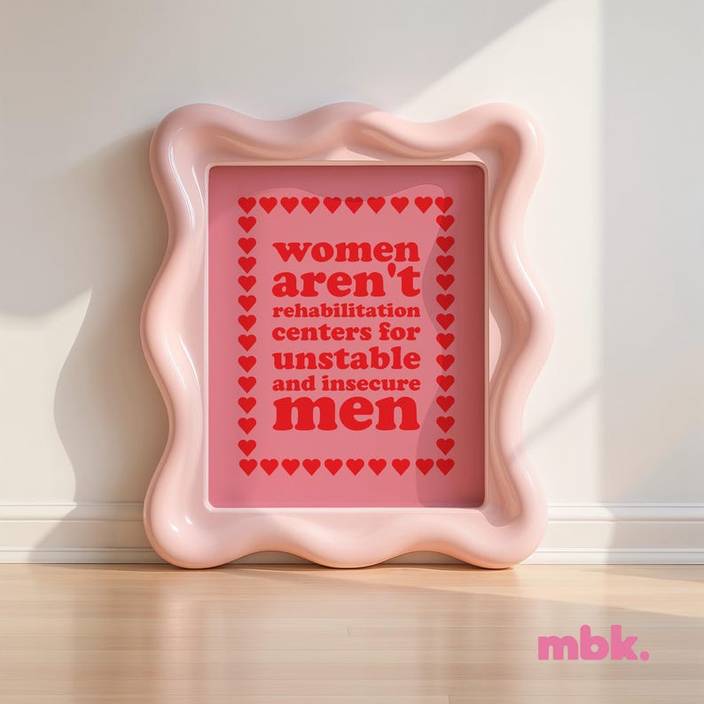 May include: Pink framed print with the text "women aren't rehabilitation centers for unstable and insecure men" surrounded by a border of red hearts.