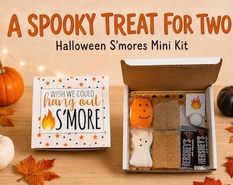 May include: A Halloween S'mores mini kit in a white box with the text 'WISH WE COULD hang out S'MORE' and a flame graphic. The open box contains two Hershey's milk chocolate bars, graham crackers, a pumpkin marshmallow, and a ghost marshmallow.