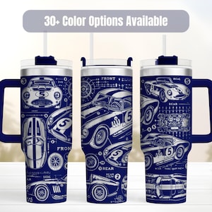 May include: Three dark blue tumblers with handles and clear lids, featuring white technical line drawings of vintage race cars with the number 5. The text 30+ Color Options Available is displayed at the top of the image.