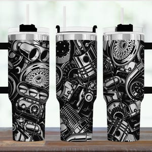 May include: Three stainless steel travel mugs with black handles and lids. Each mug features a black and white graphic design of car engine parts, including pistons, wheels, and exhaust pipes. The mugs have a silver rim and a white straw.