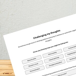 Könnte beinhalten: Ein Arbeitsblatt mit dem Titel "Challenging my thoughts" und einer Liste gängiger Denkfalle, wie z. B. "Schwarzweißdenken", "Gedankenlesen" und "Katastrophisieren". Das Arbeitsblatt enthält auch Fragen, die helfen, Gedanken zu beurteilen, wie z. B. "Ist dieser Gedanke richtig?" und "Ist dieser Gedanke hilfreich?"