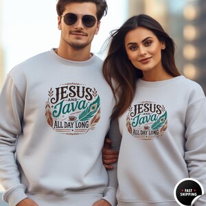 May include: Two gray sweatshirts with a graphic design featuring the text "Jesus and Java All Day Long" in brown and teal lettering with a coffee cup and feathers.