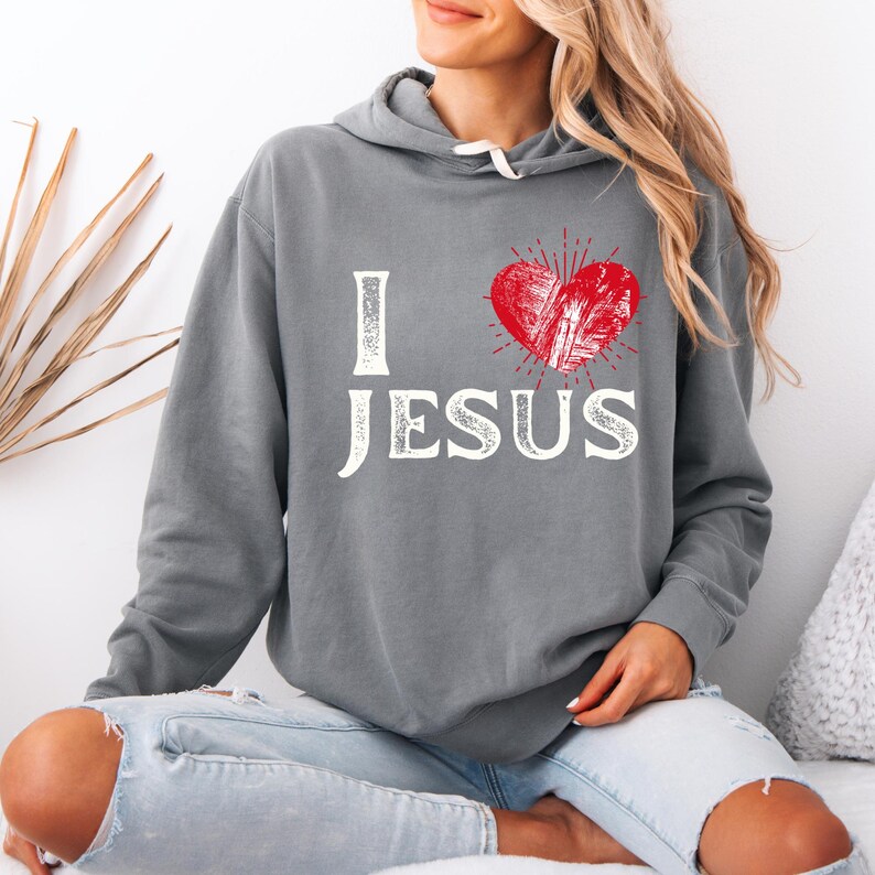 May include: Gray hooded sweatshirt with a red heart and the text "I love Jesus" in white.