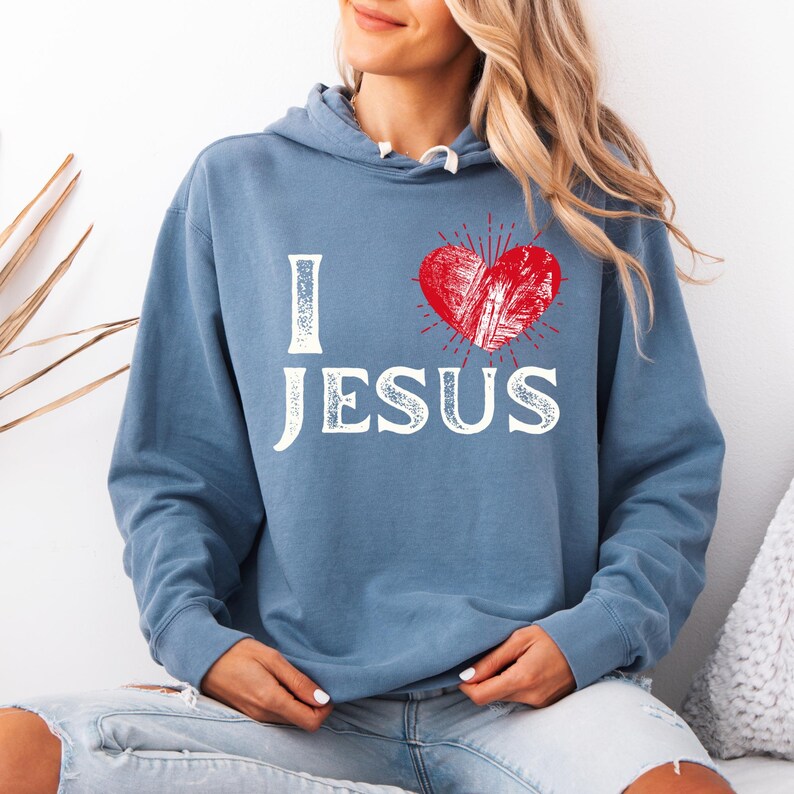 May include: A blue hooded sweatshirt with the words "I love Jesus" in white with a red heart graphic.