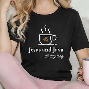 May include: Black t-shirt with a white graphic of a coffee cup with steam and coffee beans. The text "Jesus and Java... all day long" is printed below the graphic.