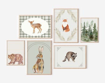 May include: Set of six watercolor animal prints featuring a fox, deer, rabbit, bear, raccoon, and a forest scene. The prints are framed in a light wood frame and have a white background.