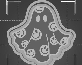 May include: A gray ghost cookie cutter with a smiling face and a pattern of smiley faces all over it.