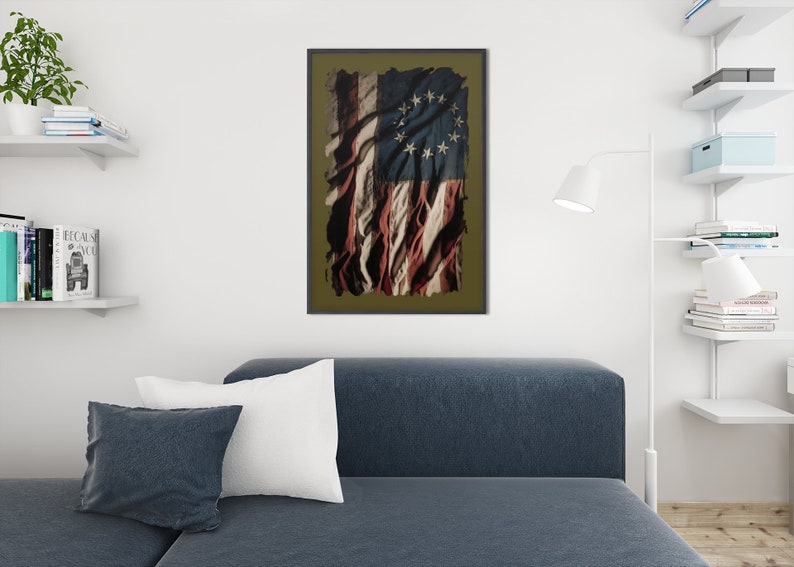 May include: A distressed, faded American flag with 13 stars in a circle. The flag is tattered and torn, with the red, white, and blue colors showing through the damage. The flag is framed in a dark brown frame.