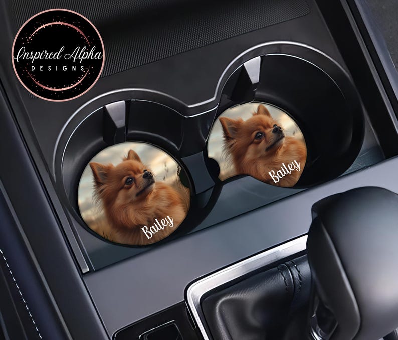 May include: Two brown and white dog car coasters with the name "Bailey" printed on each. The coasters are in a car cup holder.