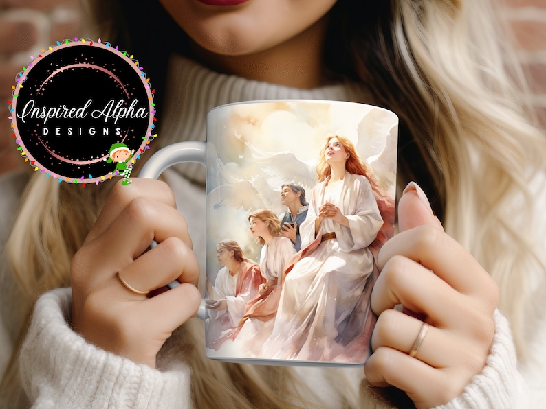 May include: White ceramic mug with a colorful image of four angels with wings, surrounded by clouds. The angels are wearing white robes and have their hands clasped in prayer. The mug has a handle on the left side.