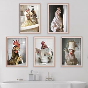 May include: Five framed prints showing chickens in a bathroom setting. One is in a bath, another in a dressing gown, a third brushing its teeth, a fourth reading a newspaper on the toilet, and the last wearing a hat. The prints are in rose gold frames.