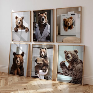 May include: Six framed art prints featuring brown bears in humorous bathroom scenes. One bear is in a bathtub, another in a bathrobe, and a third in a washing machine. Other prints show bears on a toilet, with toilet paper, and brushing their teeth.