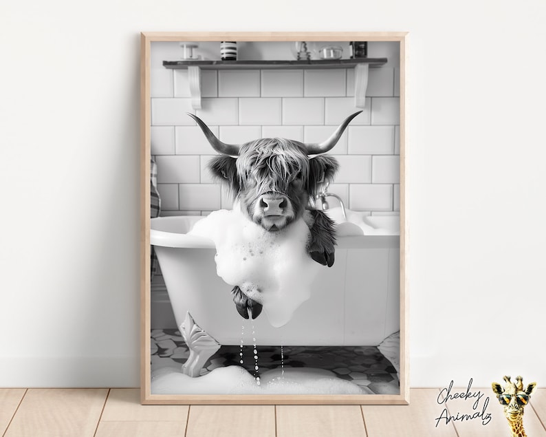 May include: A black and white photograph of a Highland cow taking a bath in a white bathtub. The cow is covered in bubbles and the water is overflowing.
