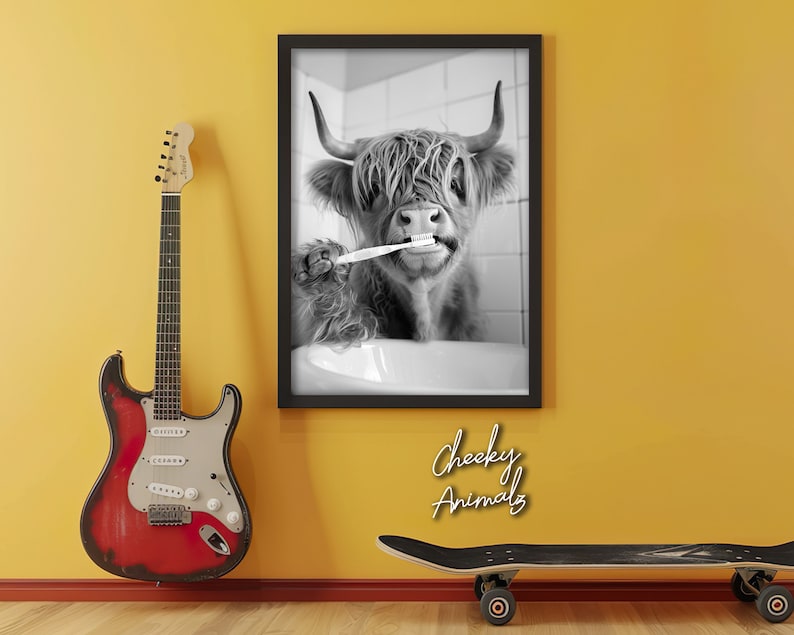 May include: Black and white photo of a Highland cow brushing its teeth with a toothbrush. The photo is framed and hanging on a yellow wall. The text "Cheeky Animals" is written below the frame.