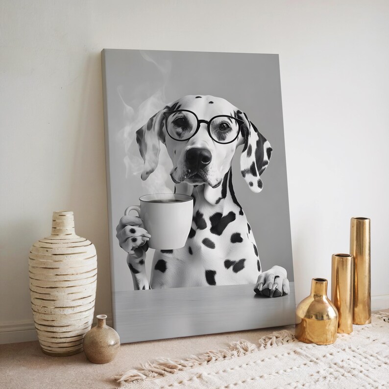 May include: Black and white photo of a Dalmatian dog wearing glasses and holding a cup of coffee. The dog is sitting at a table and looking at the camera.