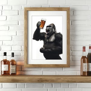May include: A framed print of a gorilla holding a glass of beer and roaring. The gorilla is in black and white, and the background is white. The frame is brown wood.